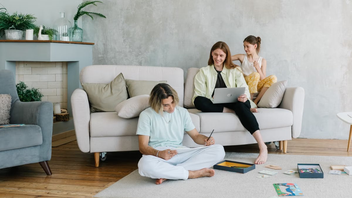 A family enjoying quality time together in a cozy living room setting, bonding and working.